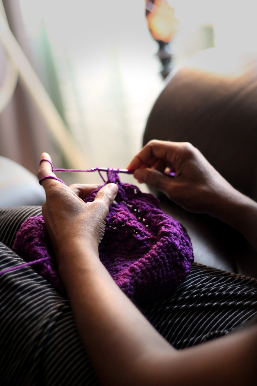 Hands stitching fabric by hand